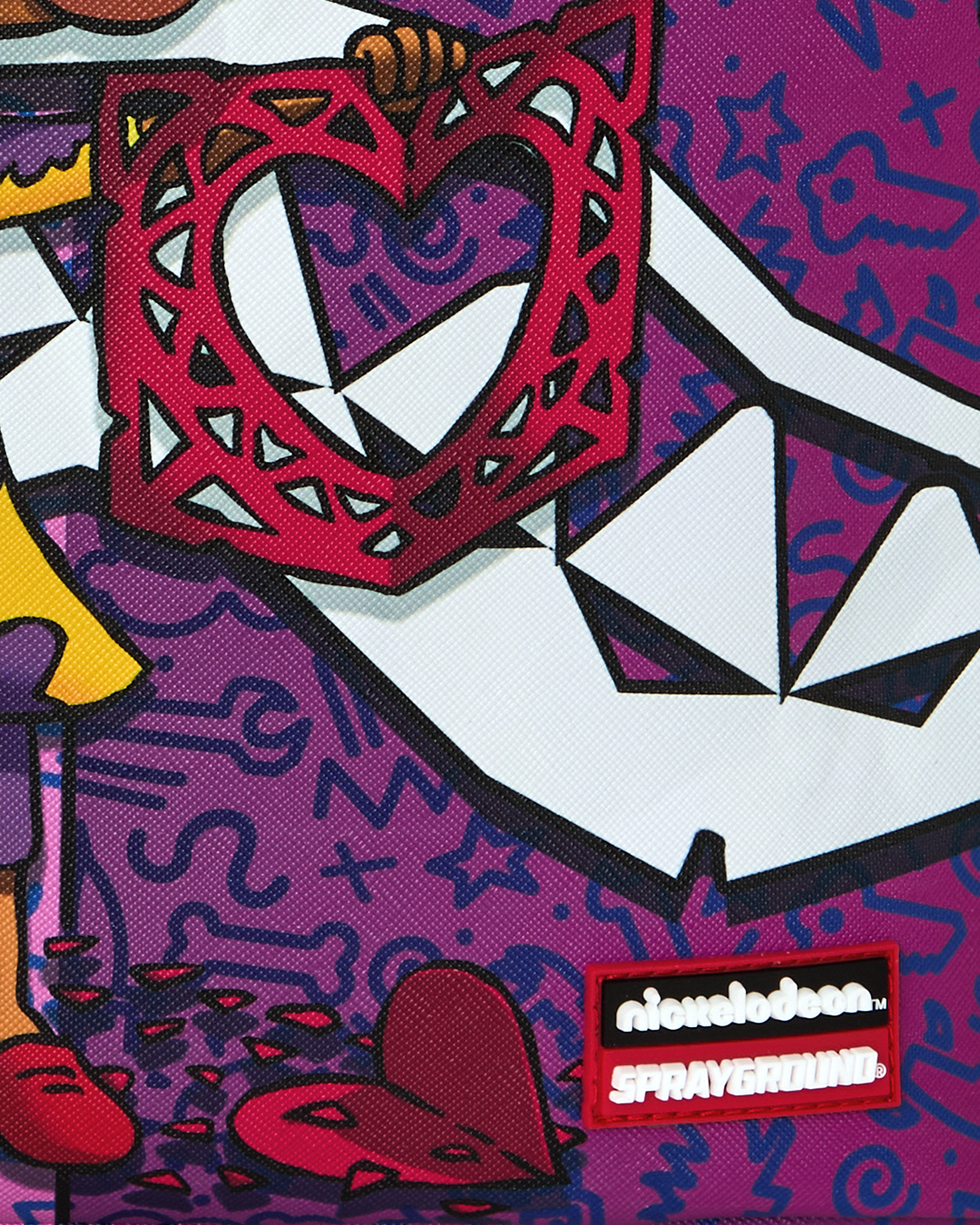 Close-up of purple backpack with Nickelodeon and Sprayground logo patch.