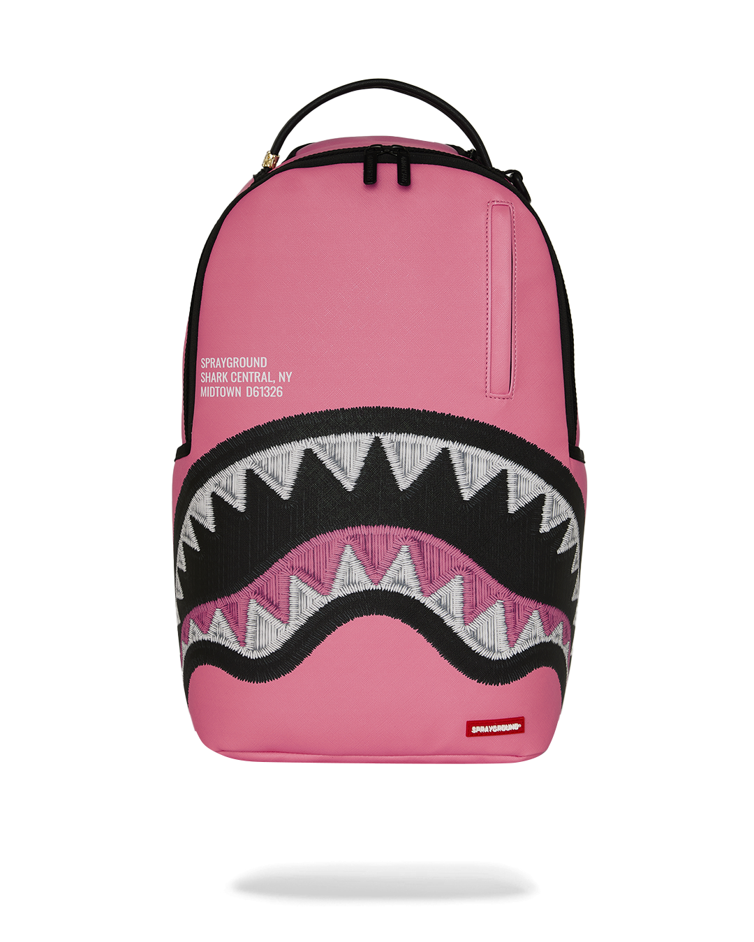 Pink backpack with black zigzag shark graphic front and top handle