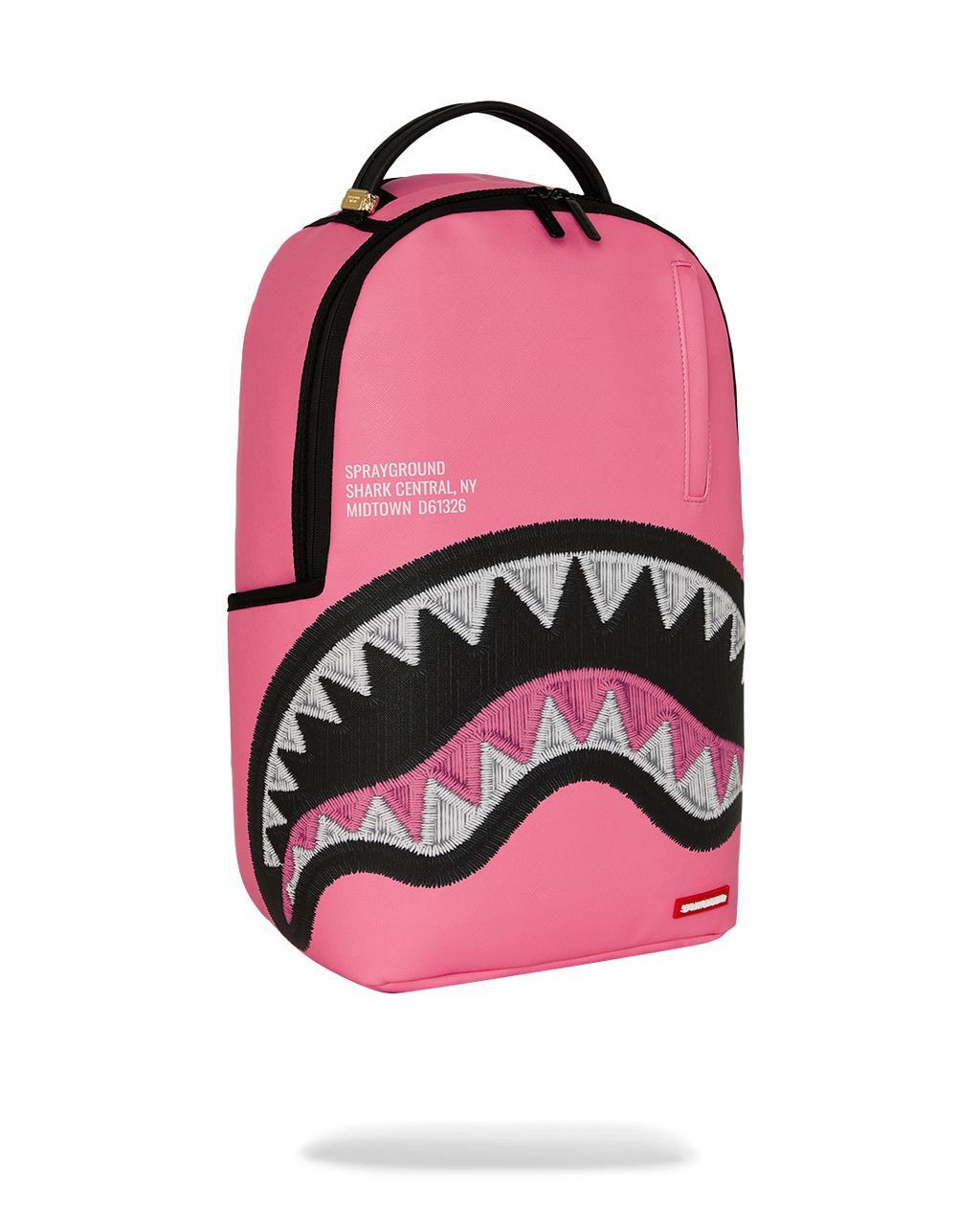 Pink backpack with top handle and black zigzag shark graphic panel