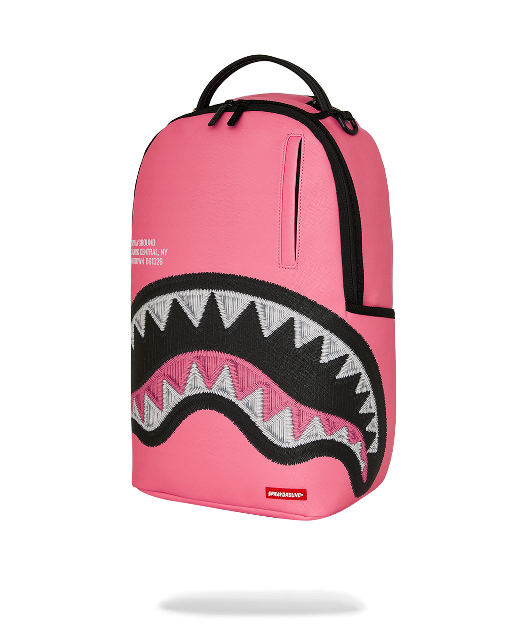 Pink backpack with side panel detailing and black zigzag shark graphic front