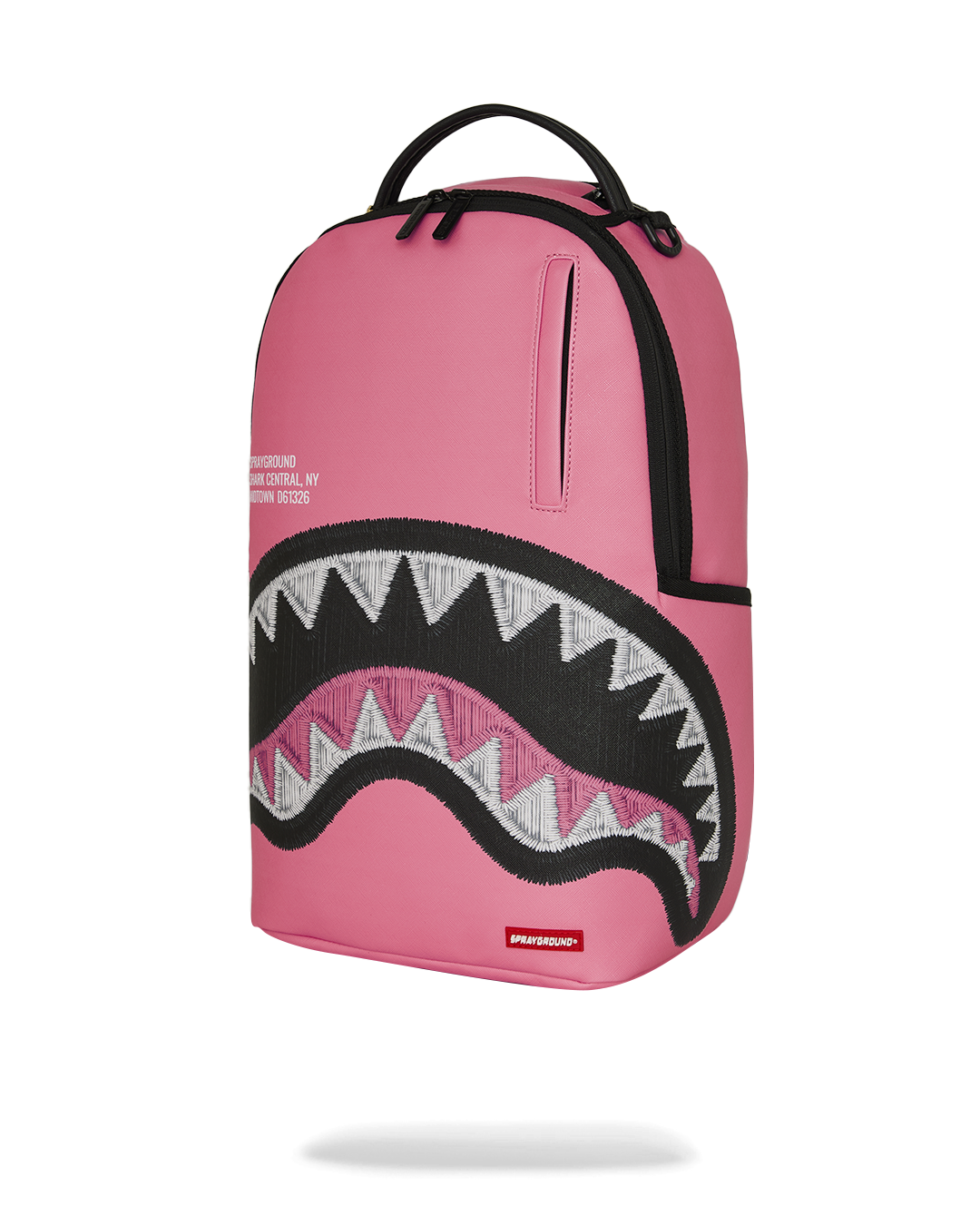 Pink backpack with side panel detailing and black zigzag shark graphic front