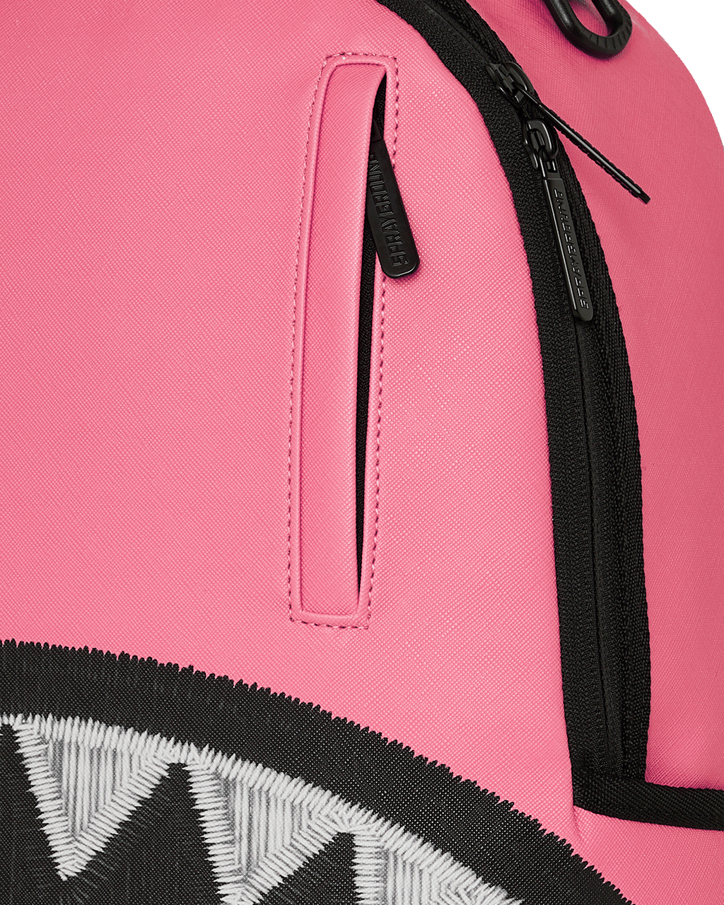 Pink backpack close-up: black zipper and vertical side pocket on front panel