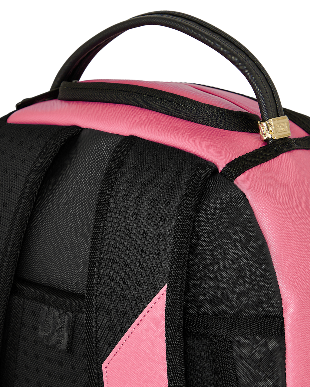 Pink and black backpack with textured front panel and gold logo hardware