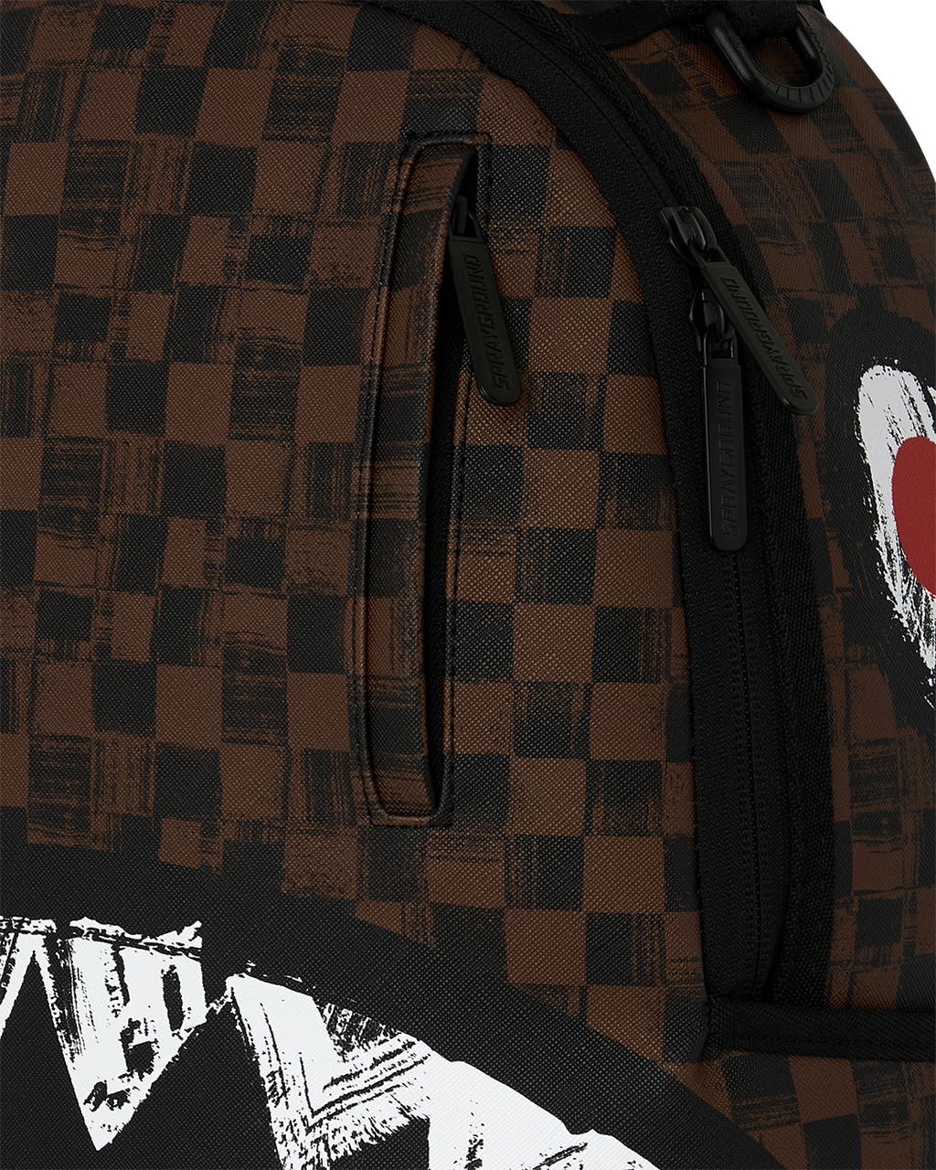 Sprayground backpack close-up of brown checkered fabric with black zipper and shark stripe