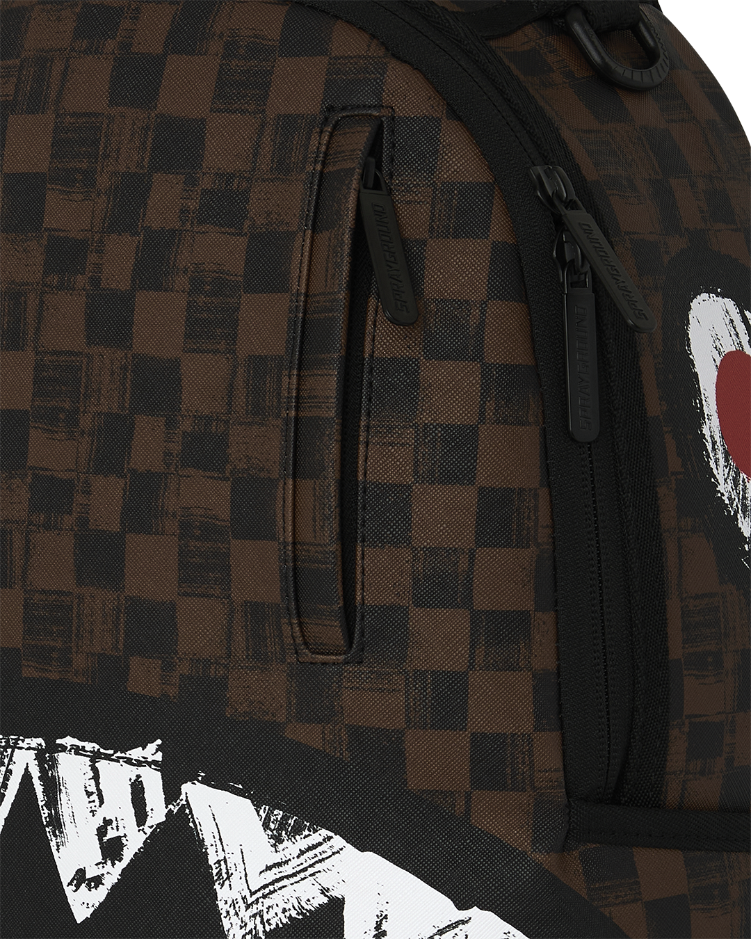 Sprayground backpack close-up of brown checkered fabric with black zipper and shark stripe