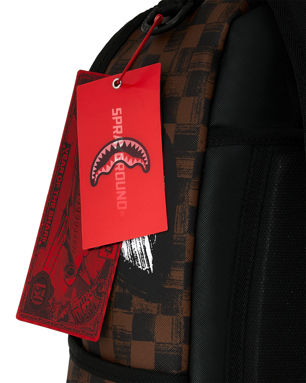 Sprayground backpack with red hanging tag on black zipper pull and strap