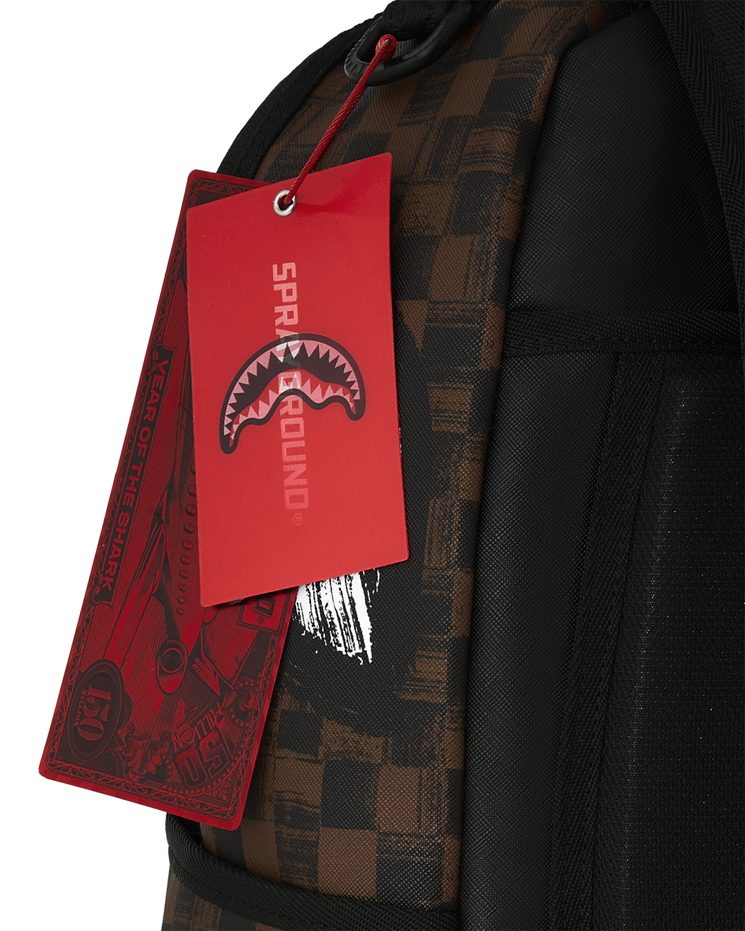 Sprayground backpack with red hanging tag on black zipper pull and strap