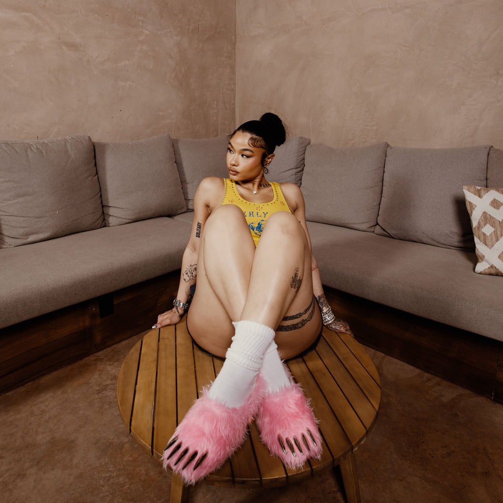 Pink bear claw mules on white socks, plush open claw toes and grippy sole