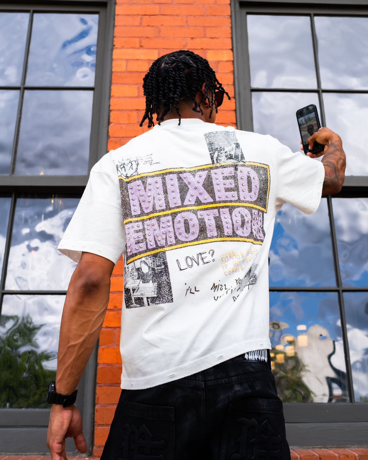 Men's white crew-neck graphic tee with 'Mixed Emotion' logo print, back view
