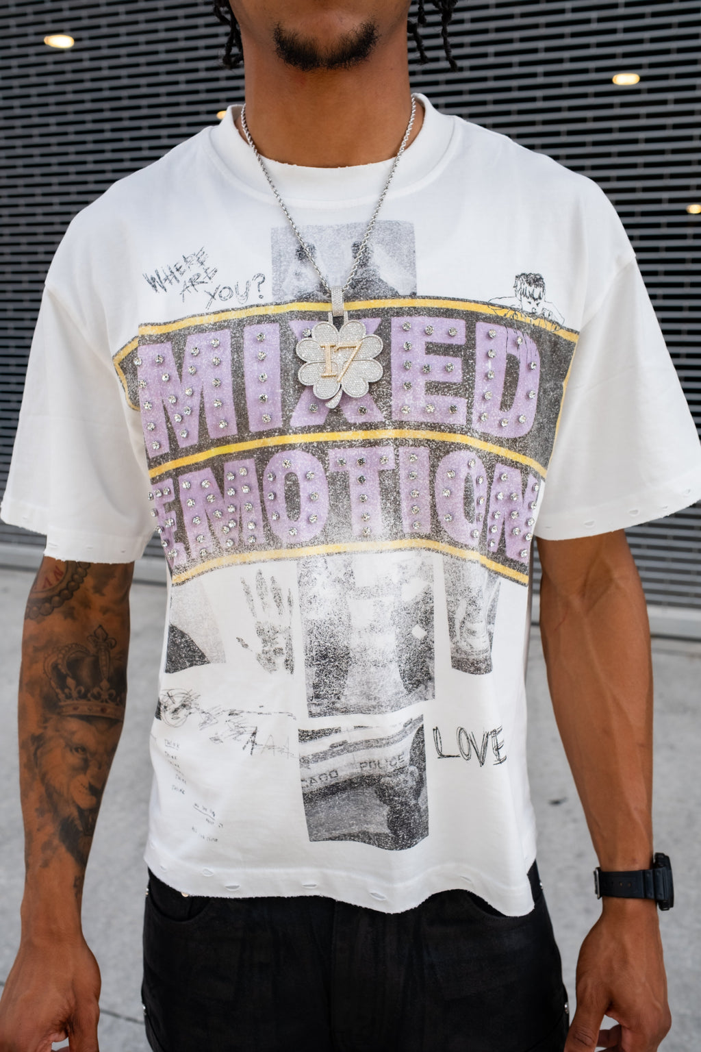 Men's white crew-neck graphic tee close-up showing collage 'Mixed Emotion' print