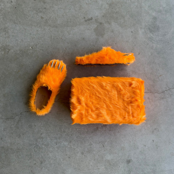 Orange plush bear-claw slippers, laid flat with matching claw-shaped toe pieces.