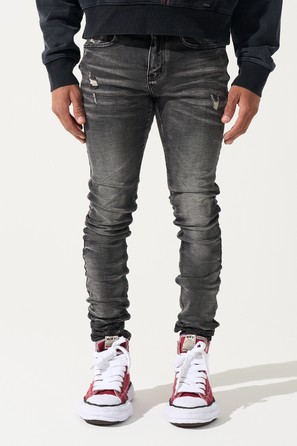 Men's slim-fit jeans in dark gray wash with distressed patches and whiskering