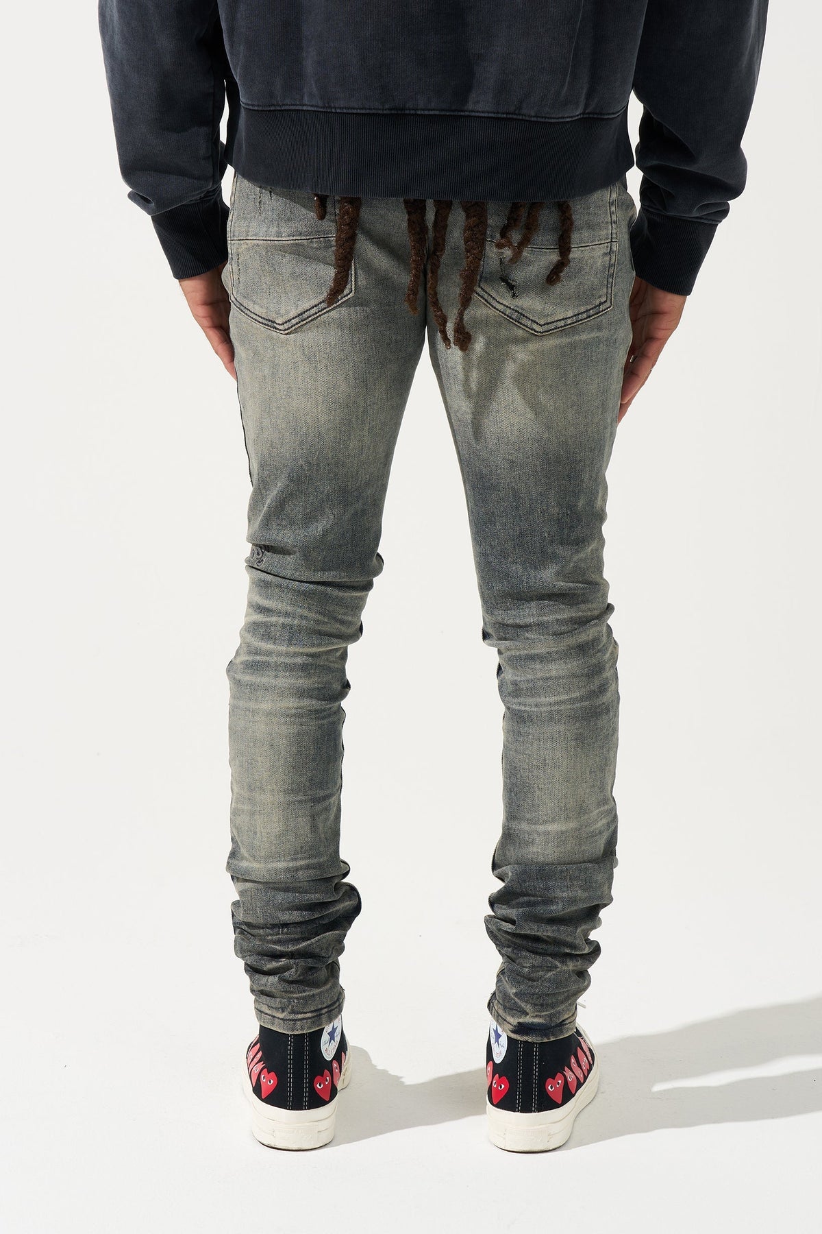 Men's gunmetal-wash slim jeans, back view, ruched ankle cuffs and two back pockets