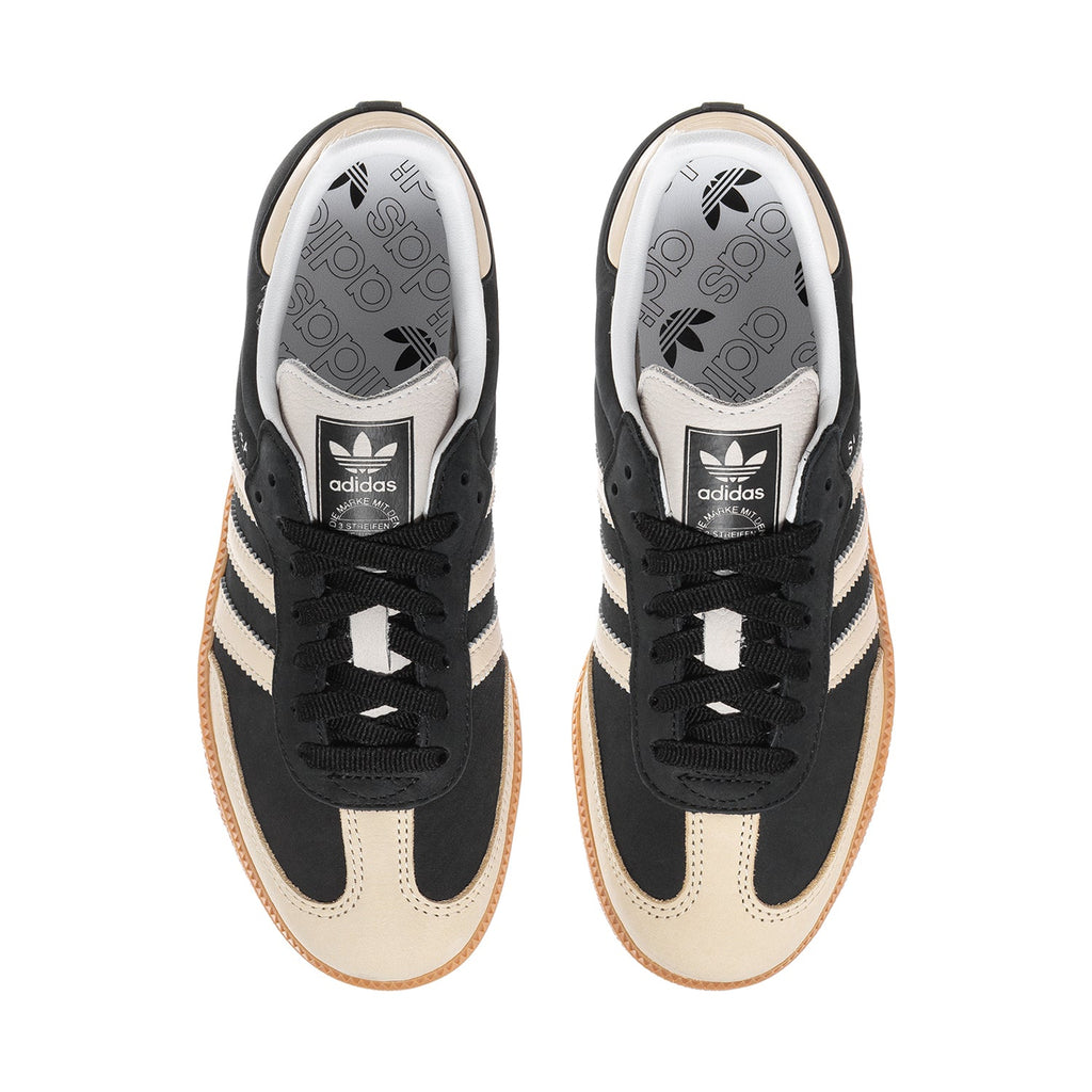 Adidas Samba OG women's shoe view: black laces, cream lining, and adidas logo on tongue.