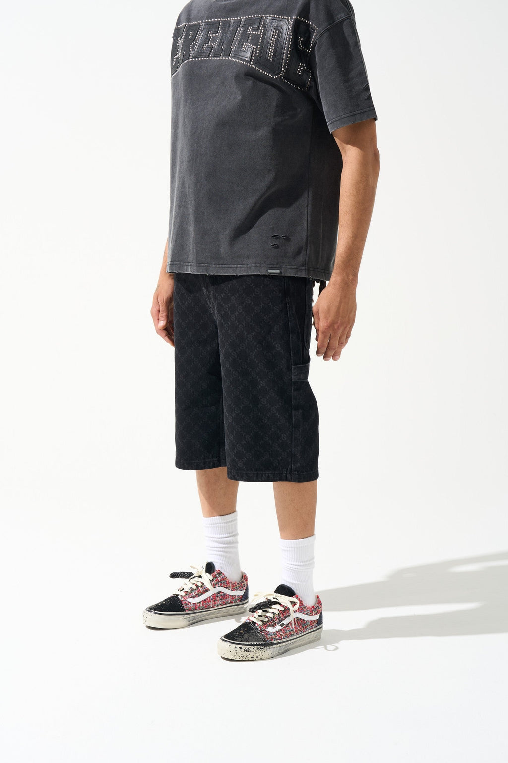 Men's black denim shorts with monogram pattern, relaxed fit above knee