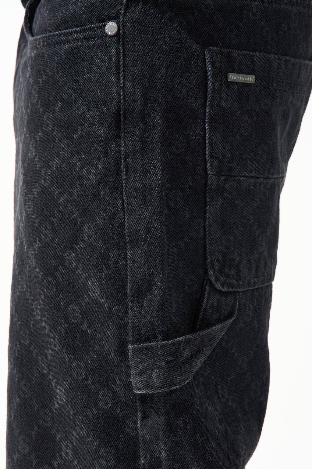 Black denim shorts close-up: stitched button and side cargo pocket with patch