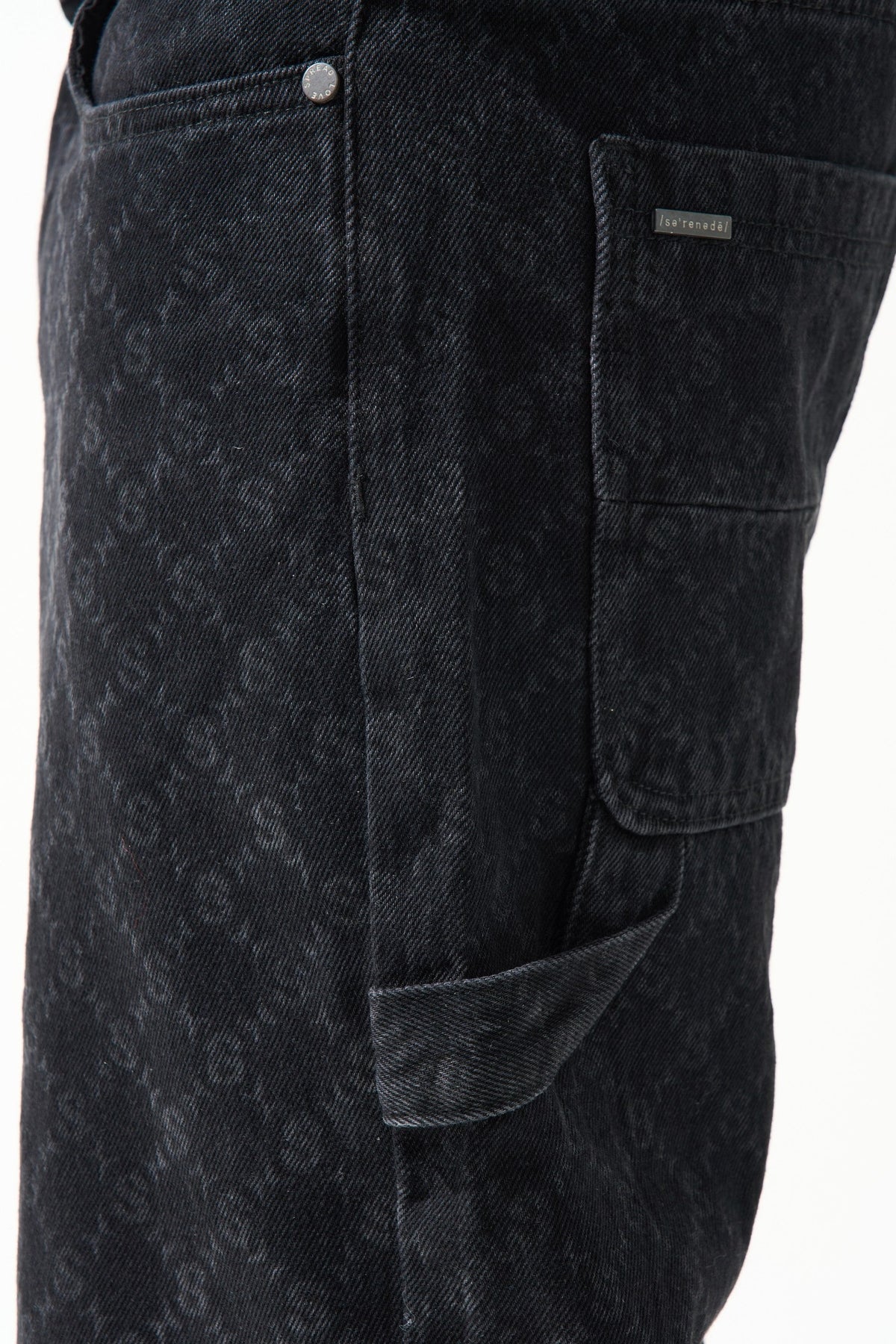 Black denim shorts close-up: stitched button and side cargo pocket with patch