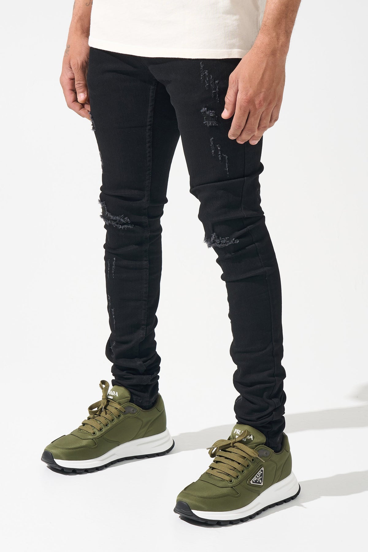 Men's black slim jeans with distressed knees and faded patchwork details
