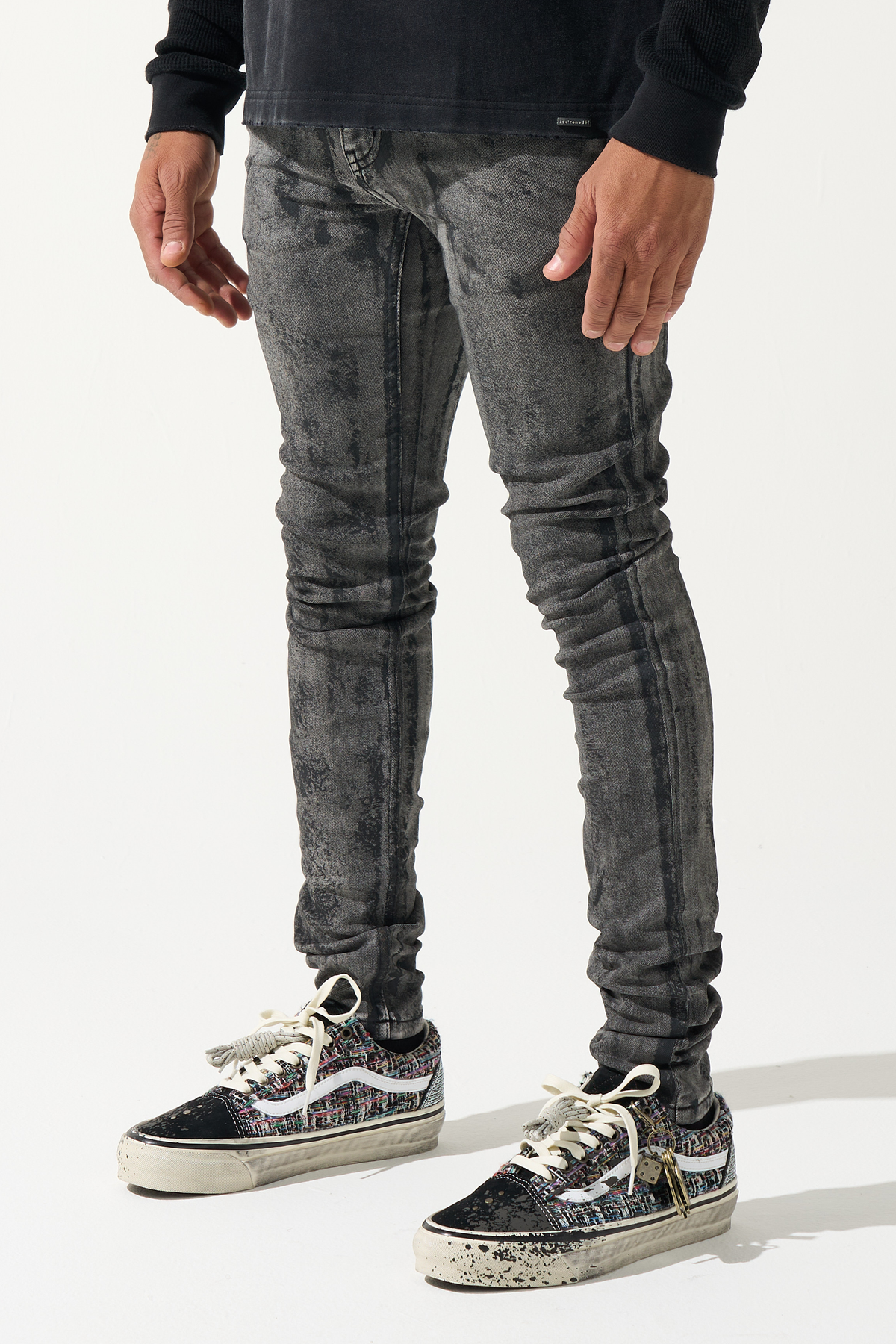 Men's charcoal washed jeans, distressed paneling, slim tapered fit.
