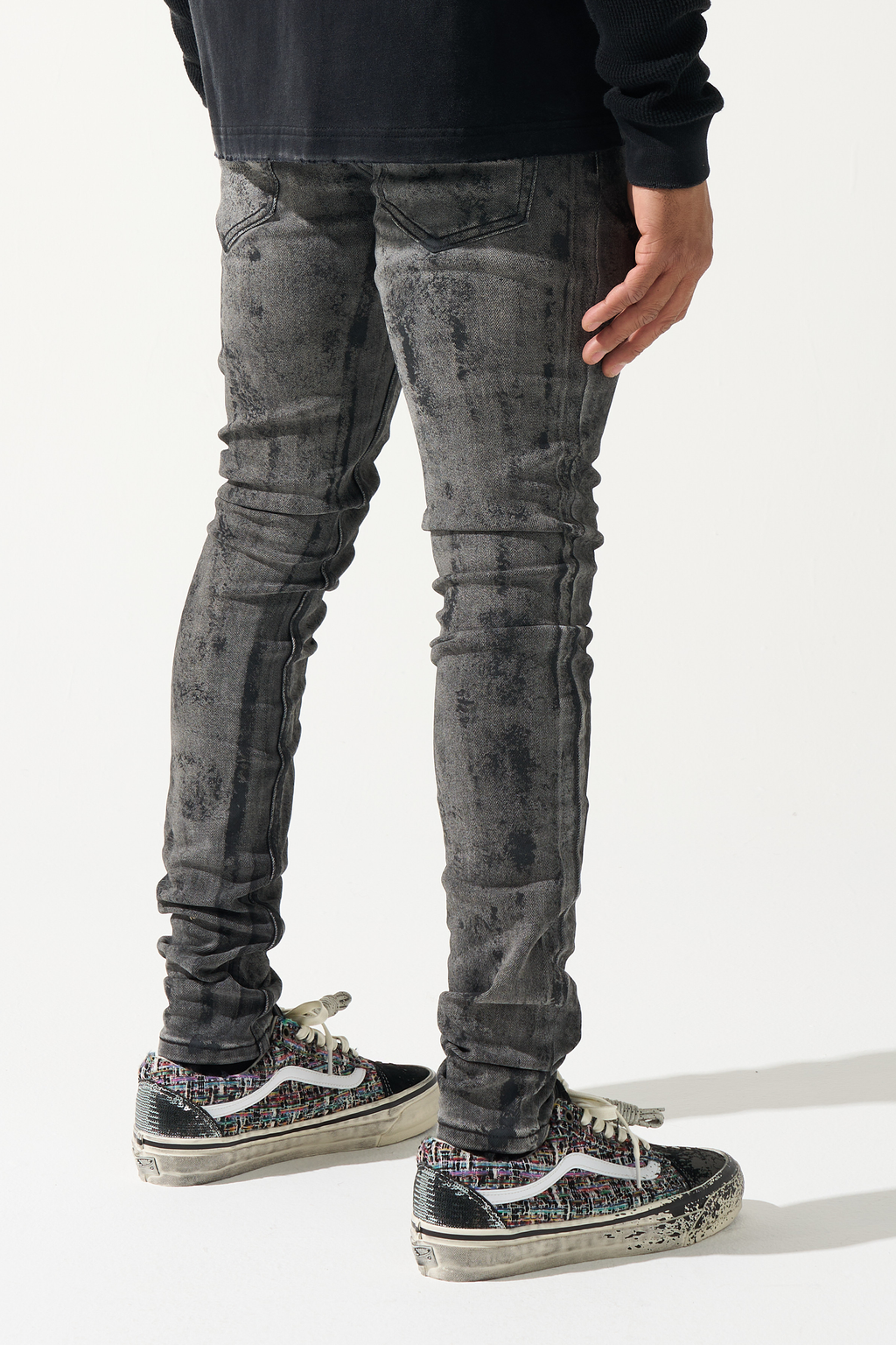 Men's charcoal washed jeans, distressed patterning, slim tapered fit.