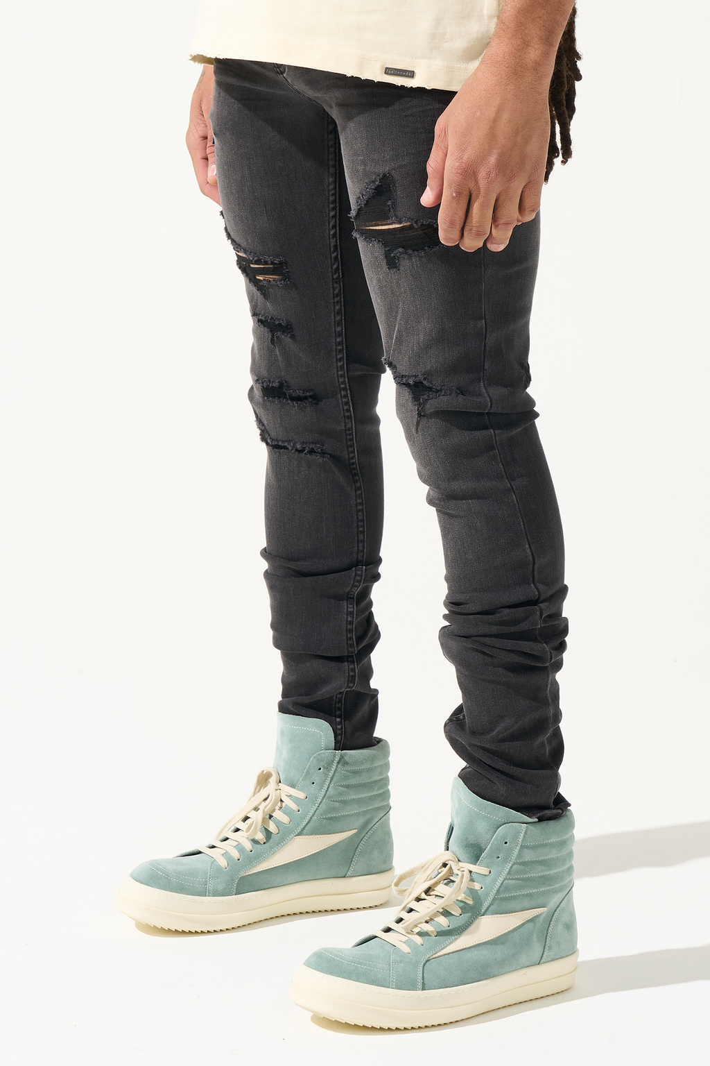 Men's charcoal skinny jeans with knee rips and stacked wrinkle texture