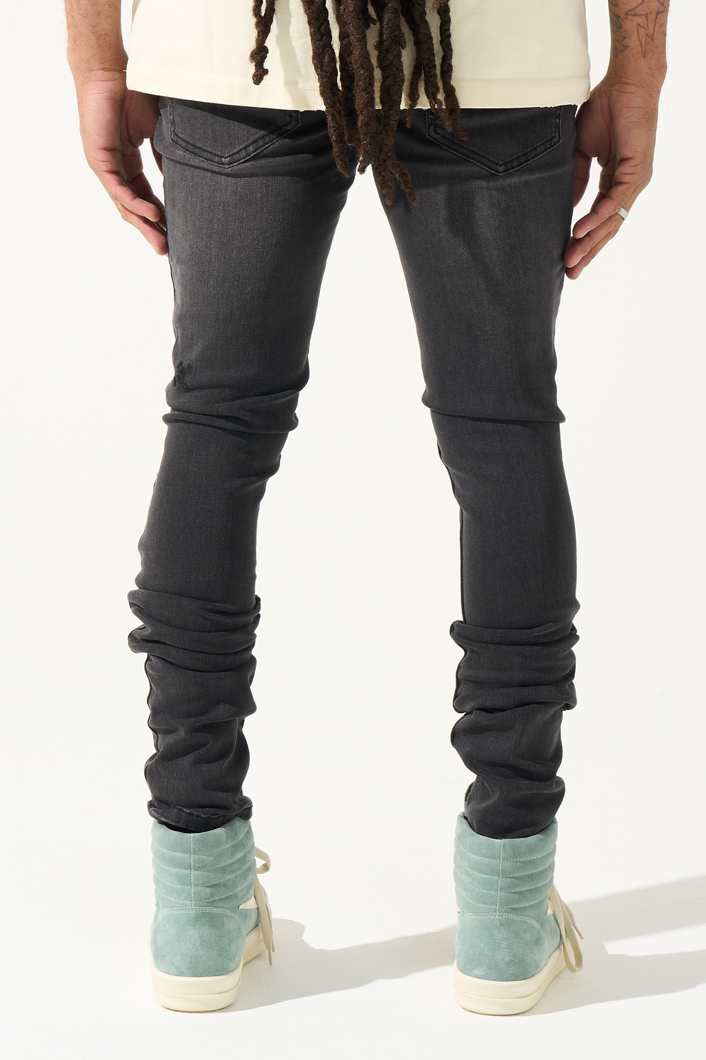 Men's charcoal slim jeans with gathered ankle cuffs and dark wash distress