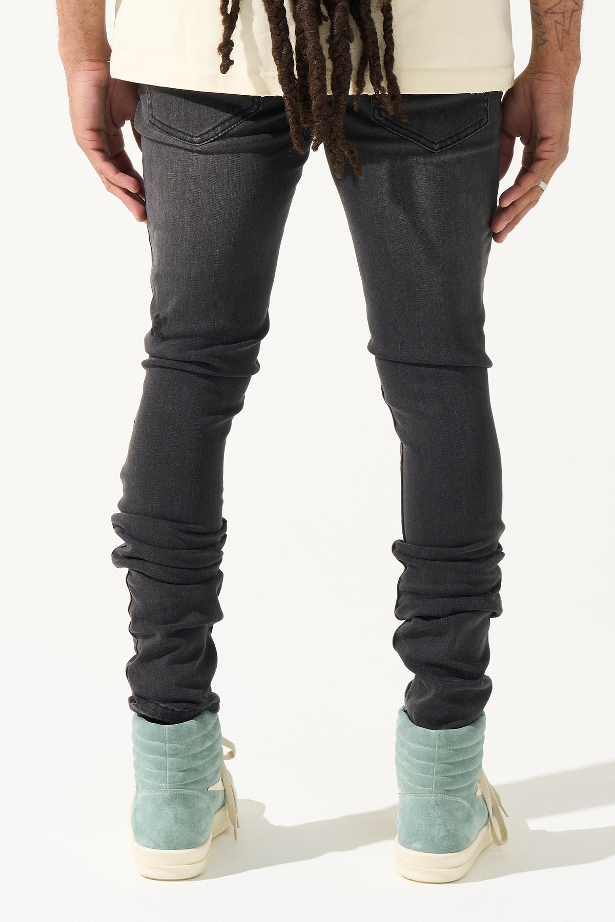 Men's charcoal slim jeans with gathered ankle cuffs and dark wash distress