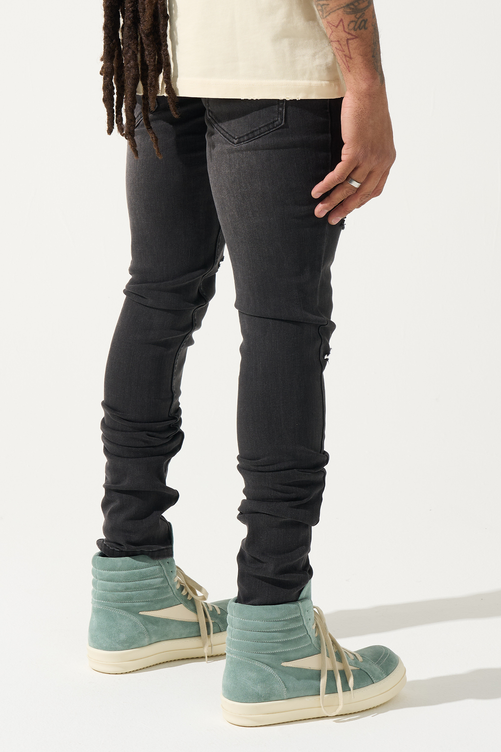 Men's charcoal skinny jeans with knee tears and slim fit denim wash, back view