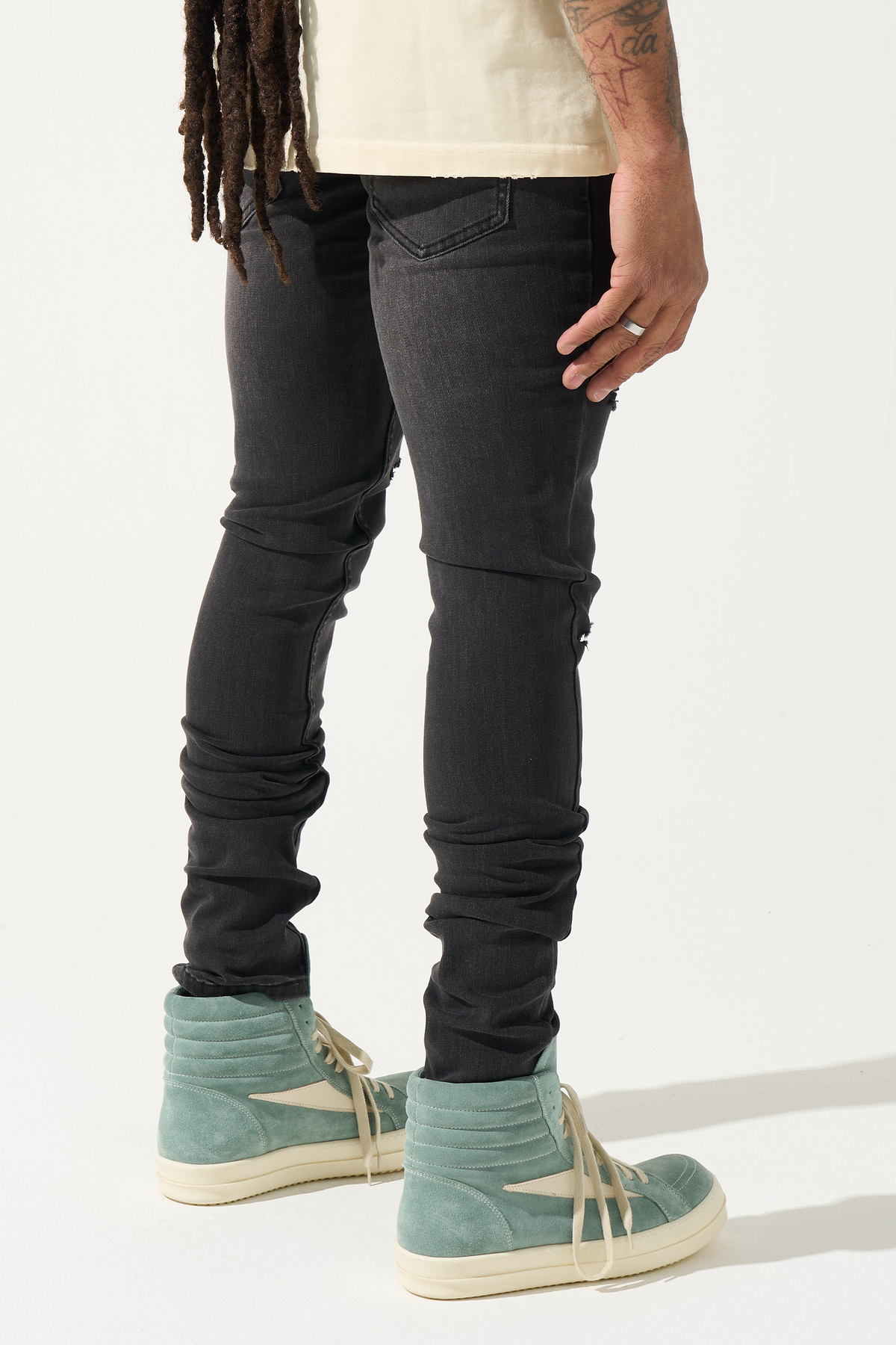 Men's charcoal skinny jeans with knee tears and slim fit denim wash, back view