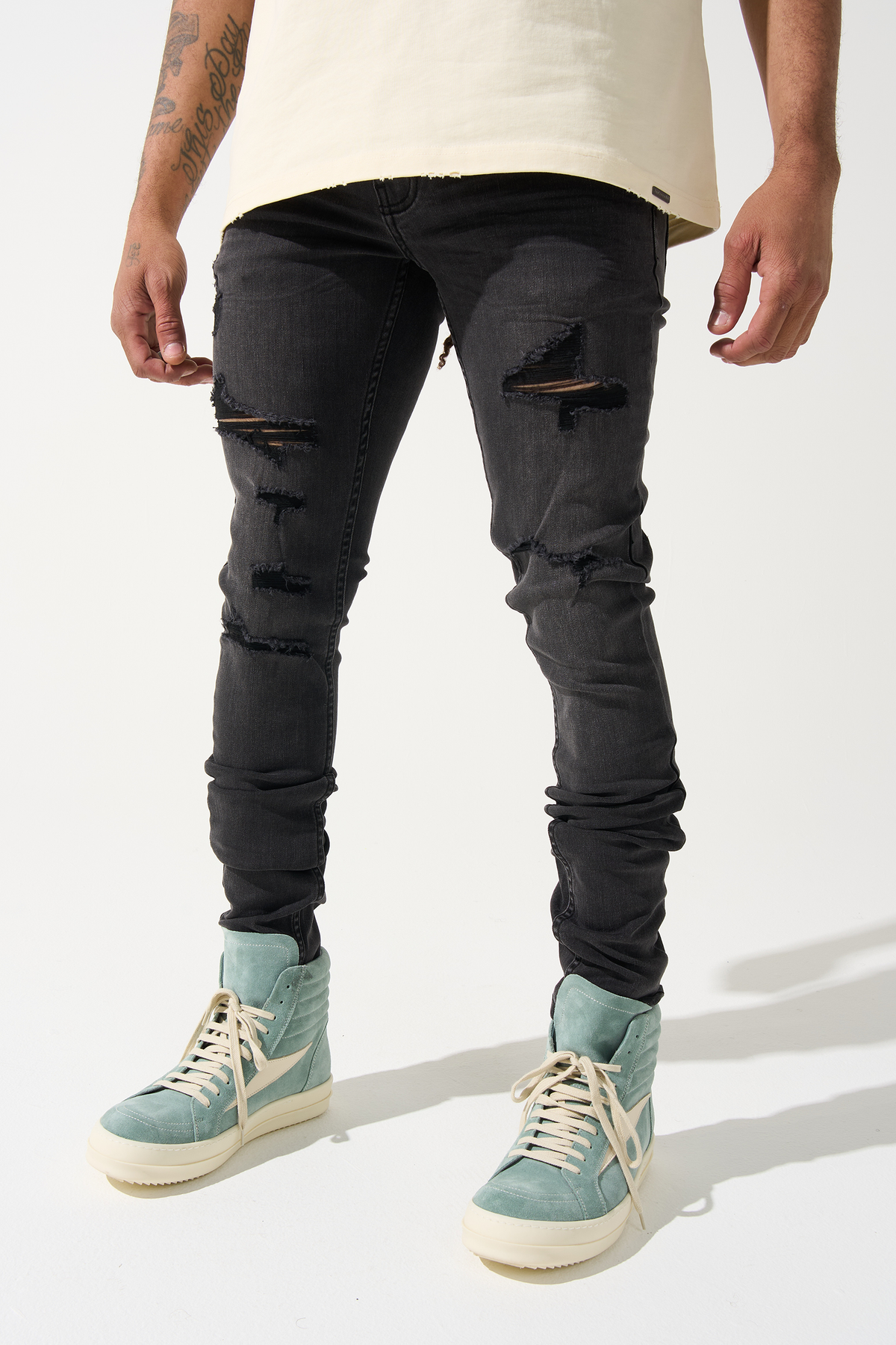 Men's charcoal slim-fit jeans with knee rips and distressed patches, zipper fly