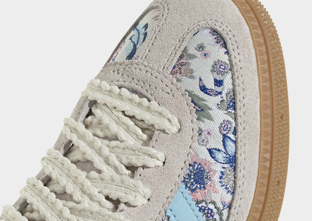 Close-up: Kids' adidas Spezial off-white suede upper with blue floral laces