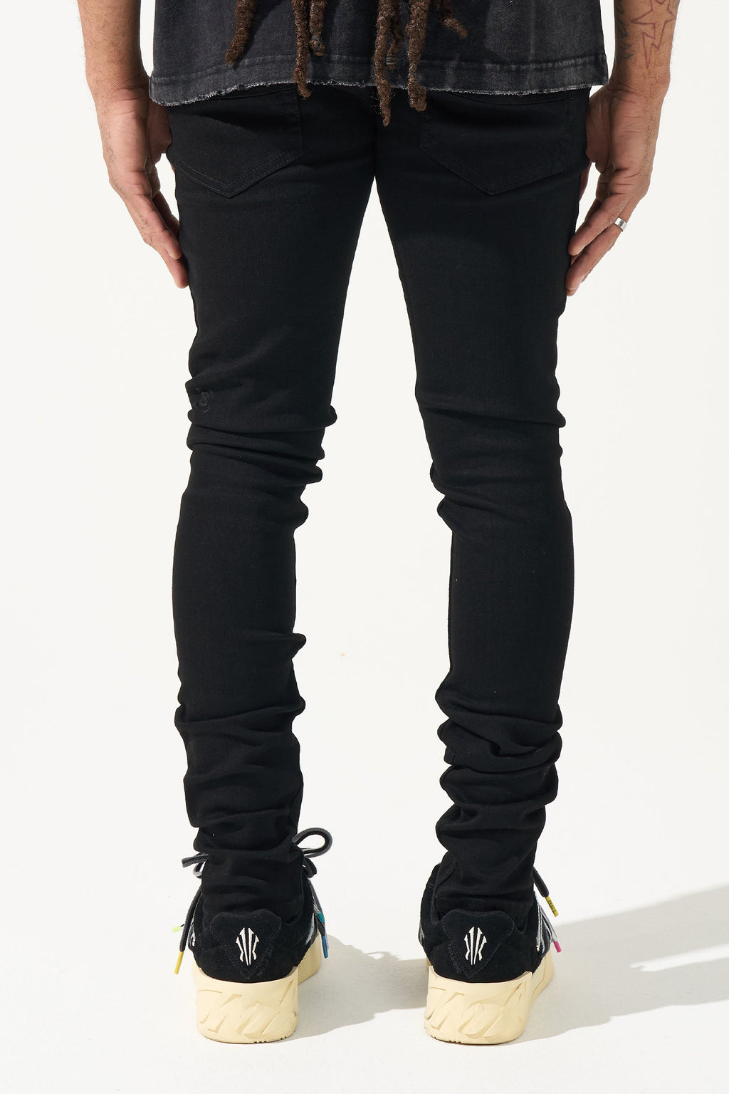 Men's black jeans from the back with gathered knee detail