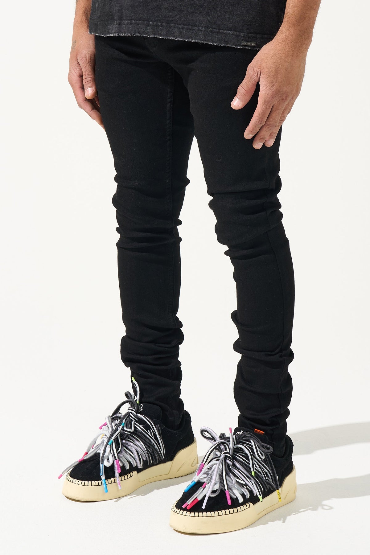 Men's black tapered jeans with gathered knee seams
