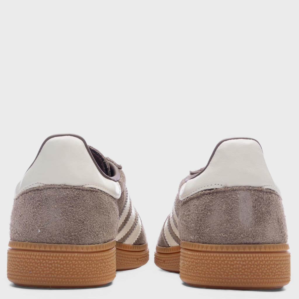 Women's suede sneaker heel view with off-white collar, gum rubber heel sole