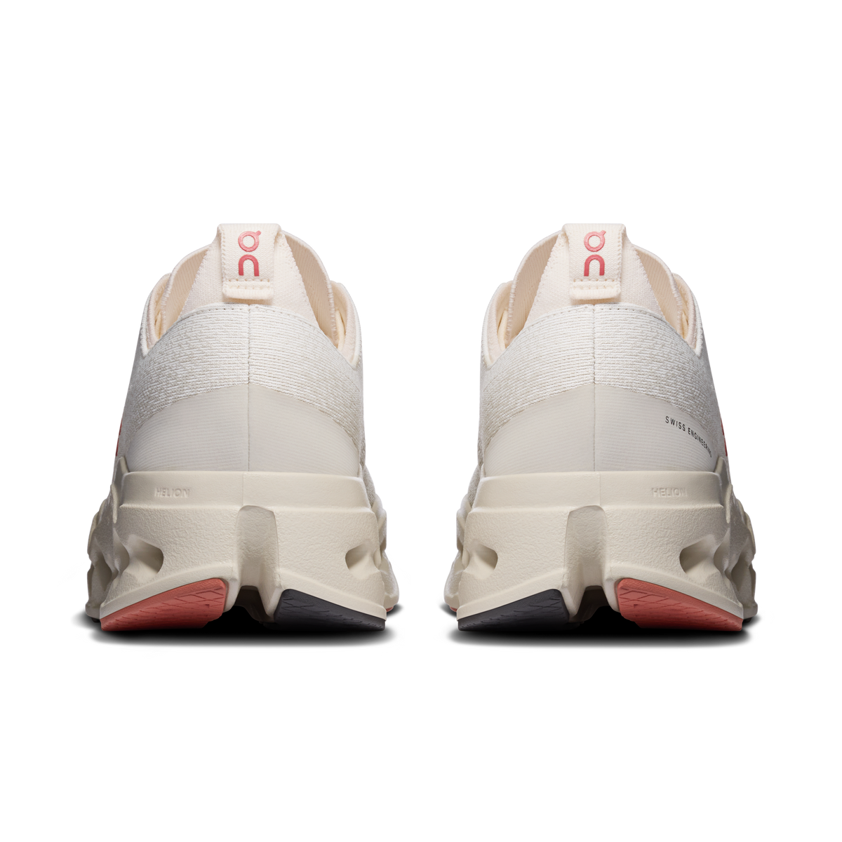On Cloudsurfer Max heel view, ivory shoes with red logo tab and cushioned rear sole