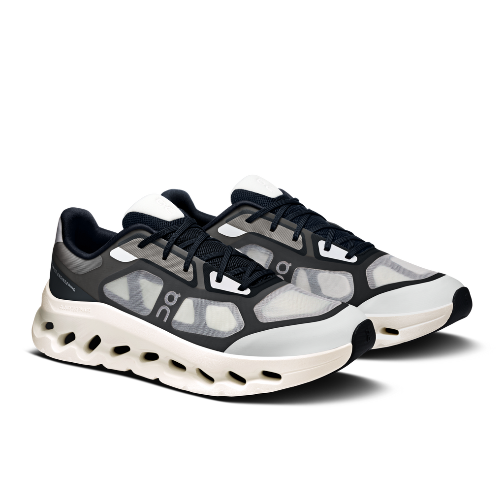Men's black and ivory lace-up running shoes with patterned side panels and cushioned sole