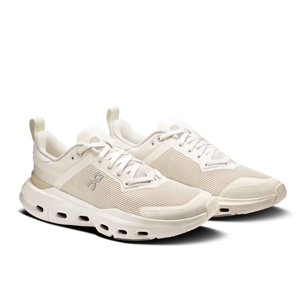 Women’s white lace-up running sneakers with textured upper and chunky CloudTec sole