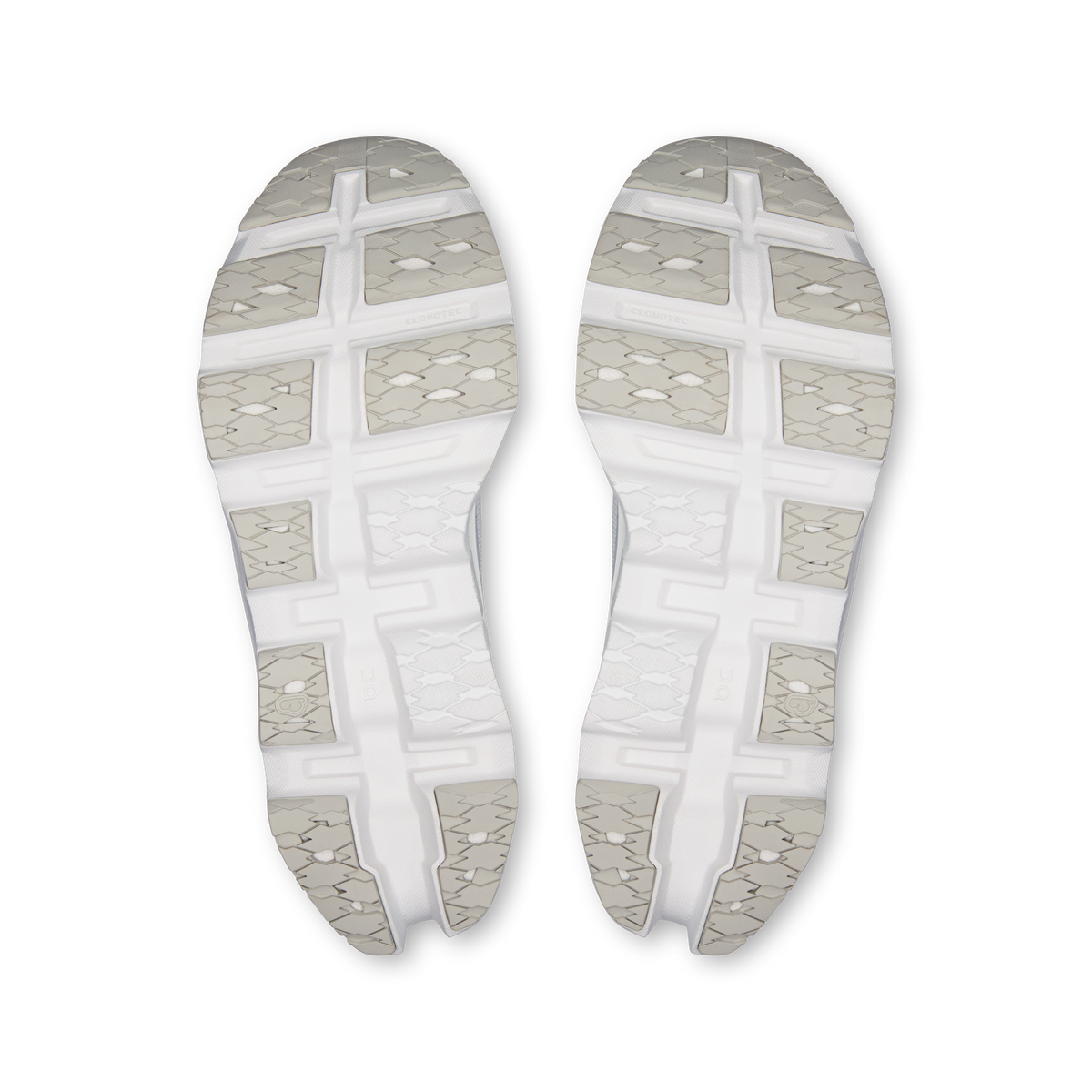 Pair of white sneaker outsoles with textured tread and gridded traction pods