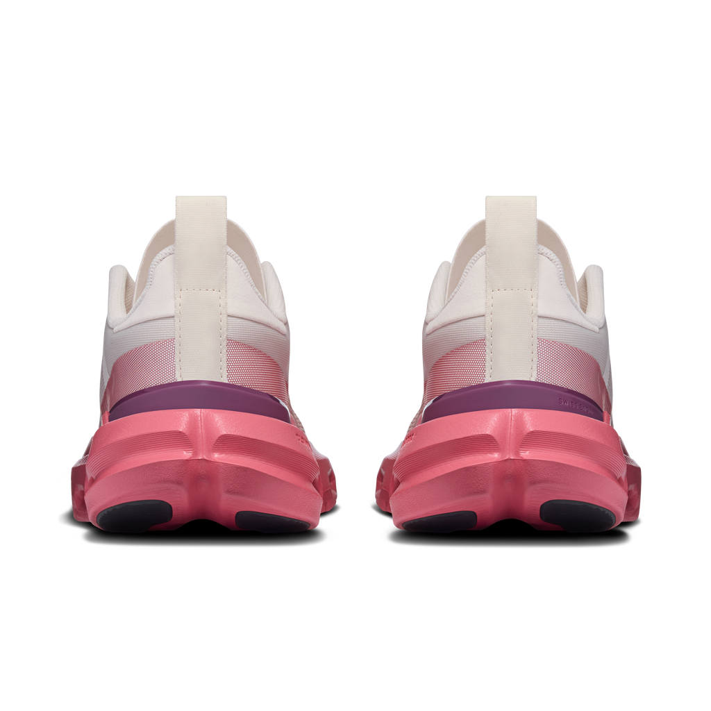 Women's running shoes heel view, white upper with pink outsole and pull tab.