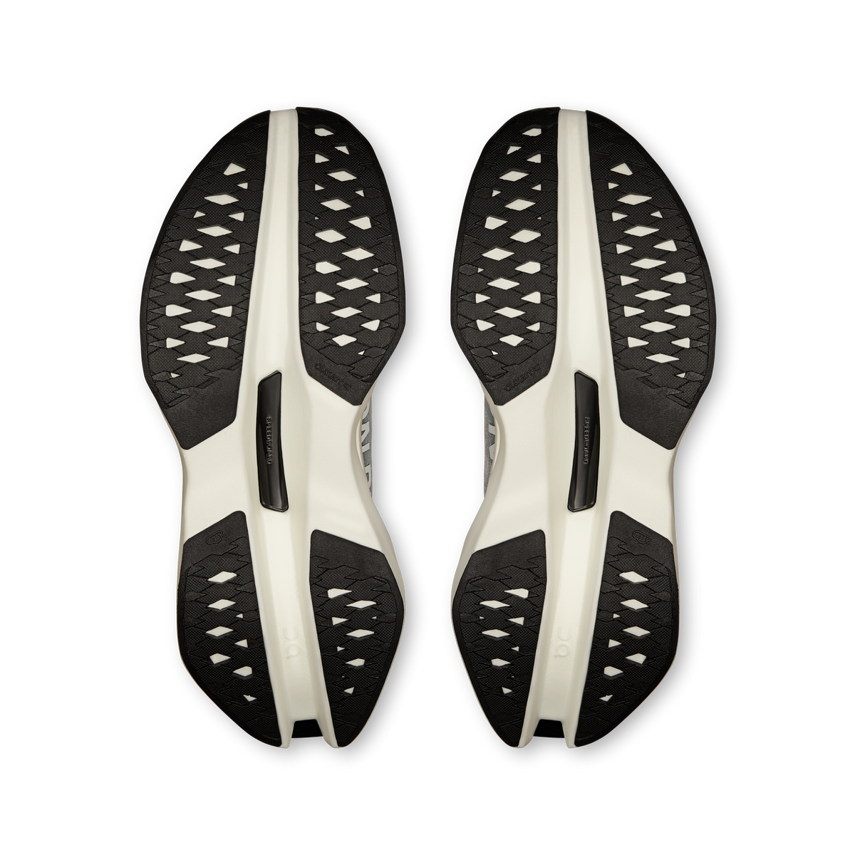 Pair of On running shoe outsoles with black tread pattern and light midsole pods