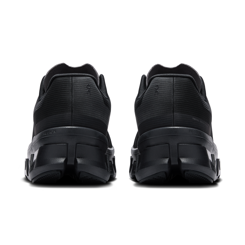 Women's black running shoes with cushioned heel and rear tread detail