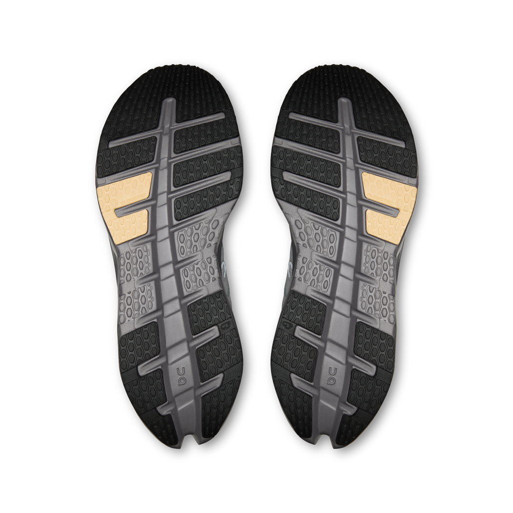 Shoe outsole pair with dark tread and gold heel inserts on light gray base