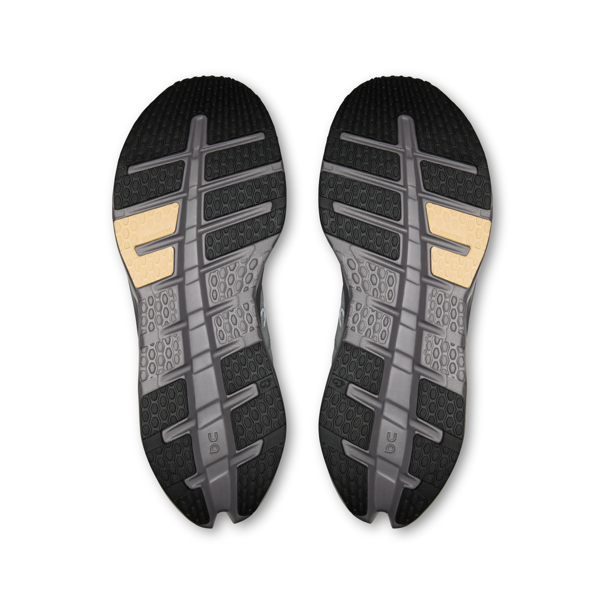 Shoe outsole pair with dark tread and gold heel inserts on light gray base