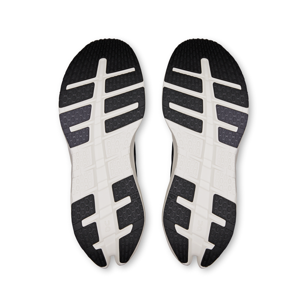 Pair of black and white outsoles with tread pattern and logo details