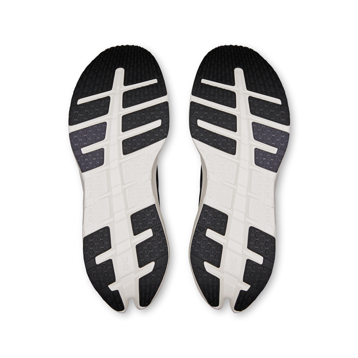 Pair of black and white outsoles with tread pattern and logo details