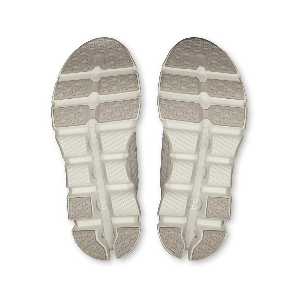 Women’s shoe outsole pair with light gray tread and white cushioning pods