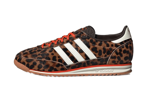 Leopard print low-top sneakers with three white adidas stripes, orange laces