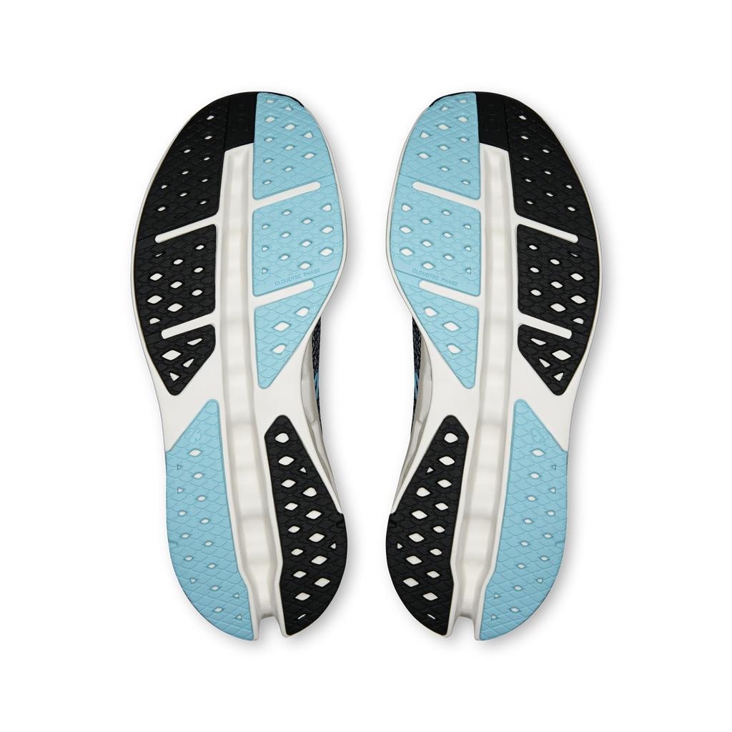 Pair of shoe outsoles with light blue inserts and black traction pods
