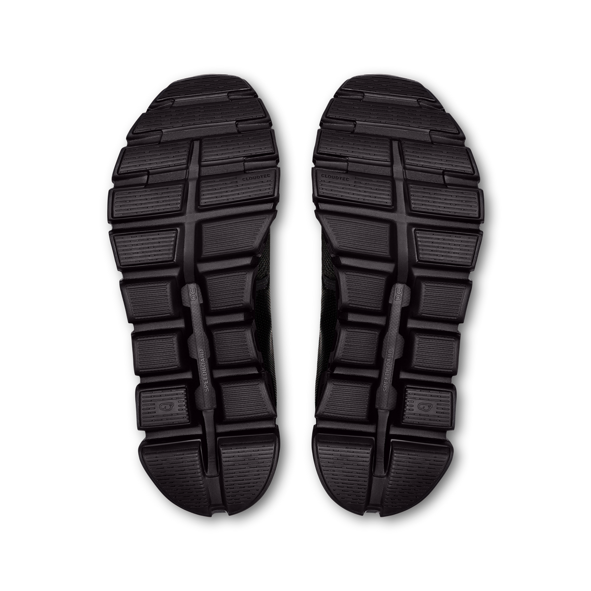 On wide running shoe outsoles in black, treaded rubber underside pair