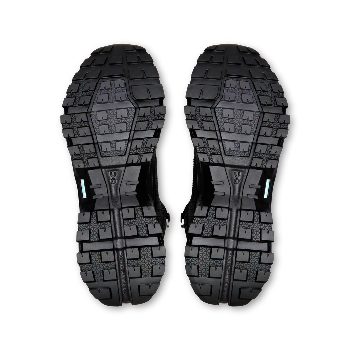 Pair of black shoe outsoles with blocky traction pattern and drainage channels
